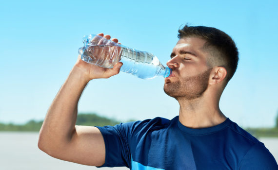 Man Drinking Water After Running. Portrait.